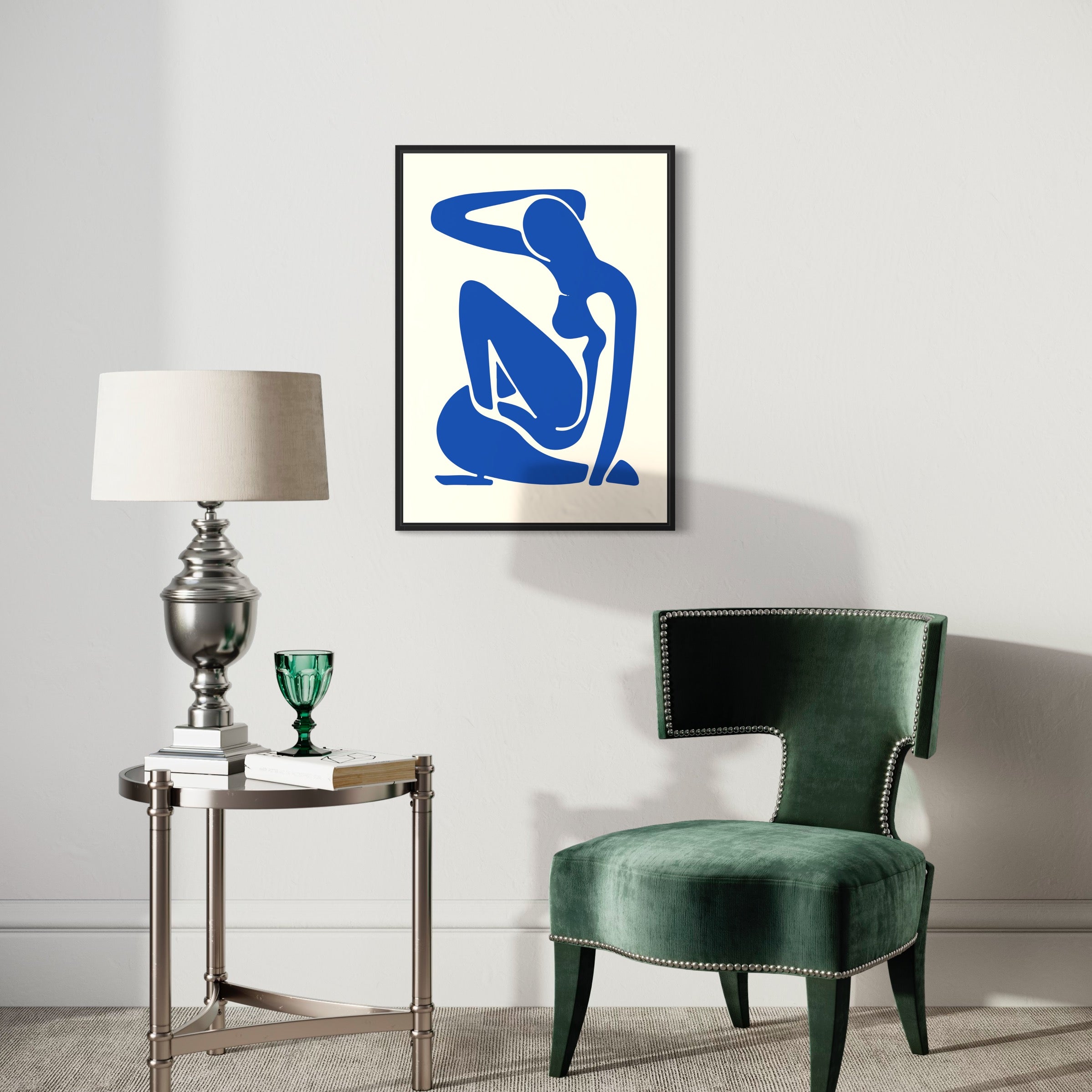 Modern living room with abstract blue art poster, velvet chair, lamp and side table
