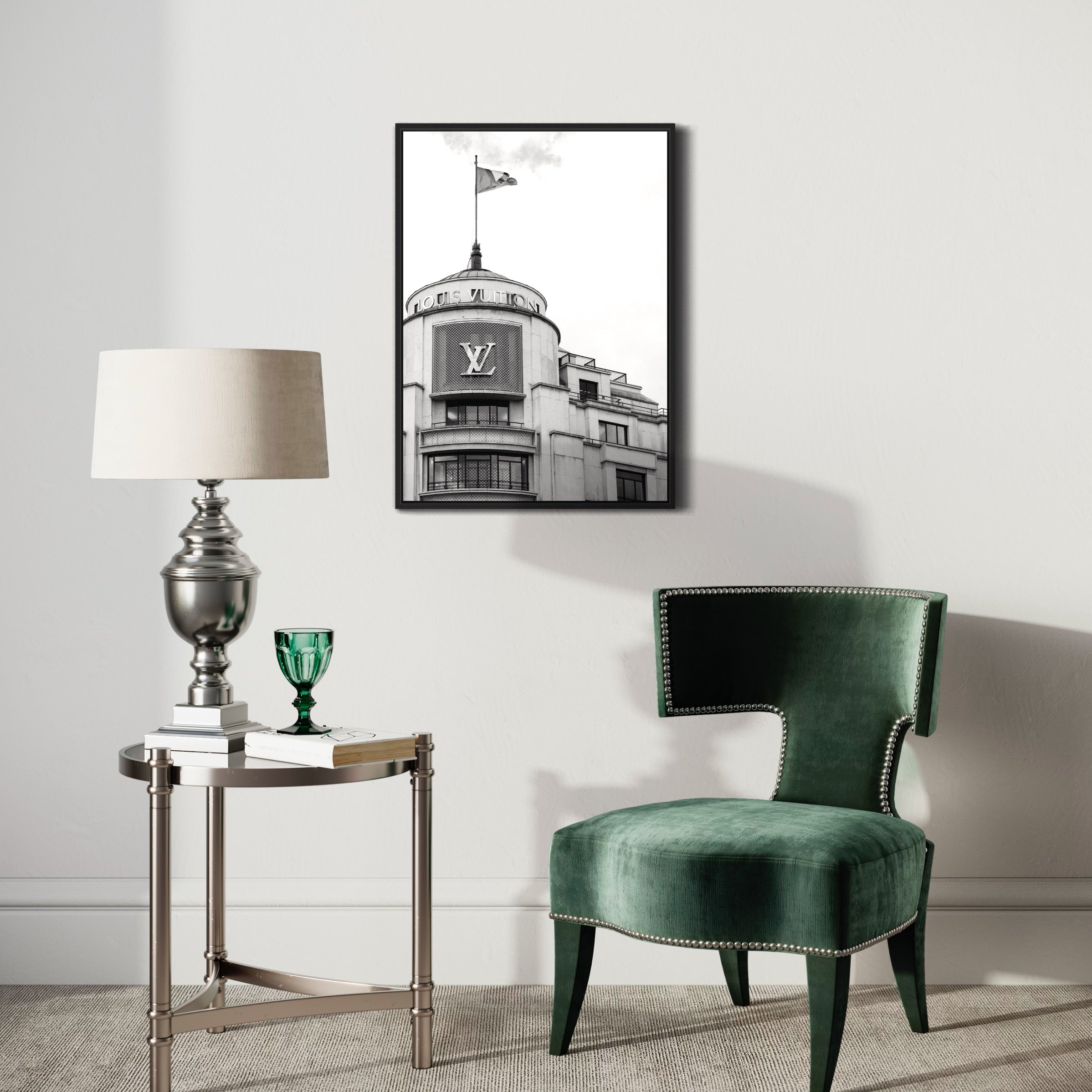 Modern living room with framed black and white building poster, green chair, and lamp