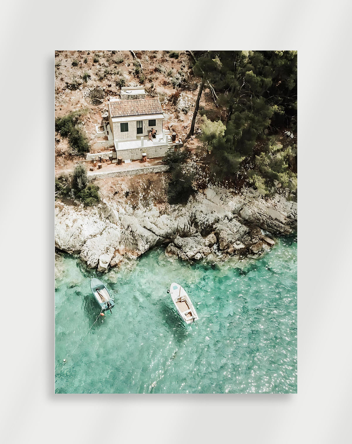Coastal house boats poster with an aerial view of a stone house by turquoise water with two boats