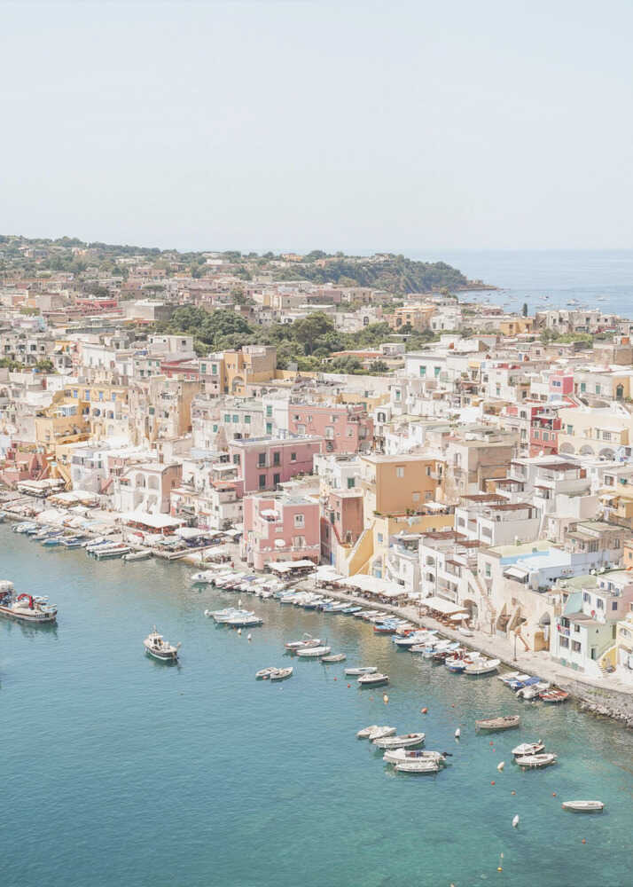 Colorful coastal town poster with a high-angle view of colorful buildings and boats in a harbor