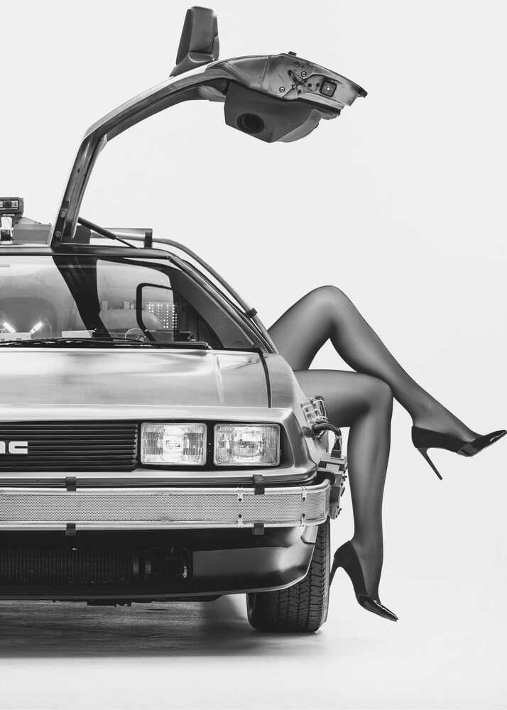 DeLorean poster with a black and white view of a DeLorean and legs in heels