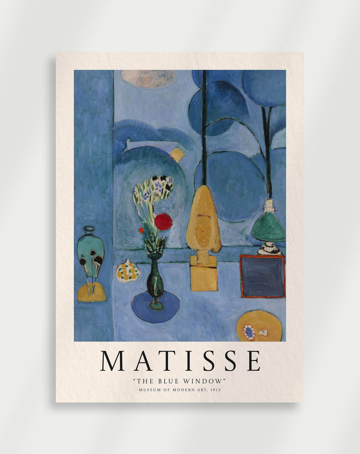 A poster of 'The Blue Window' artwork by Henri Matisse, featuring a vibrant blue background with abstract patterns and a window with a view of a botanical garden.